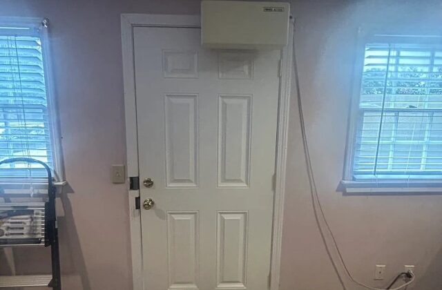 Open Sesame automatic door opener mounted above an interior door