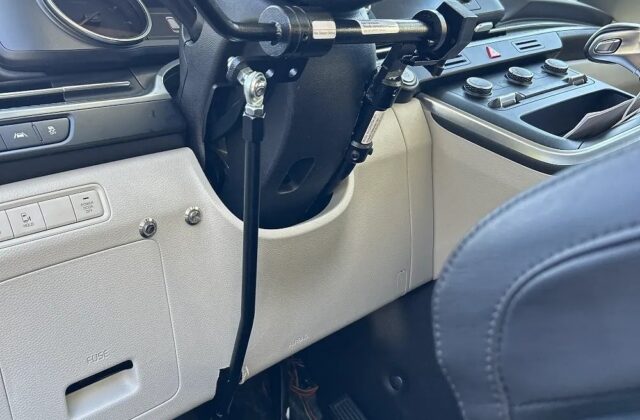 MPS Electronic Monarch left-side push-rock hand control installed in a car, its rod running down to the pedals