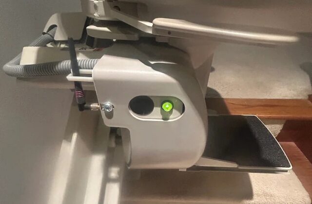 Bruno curved stairlift carriage on its rail at a turn, close up from above