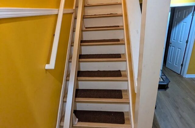 Bruno Elan SRE-5000 stairlift installed on a straight staircase beside a yellow wall