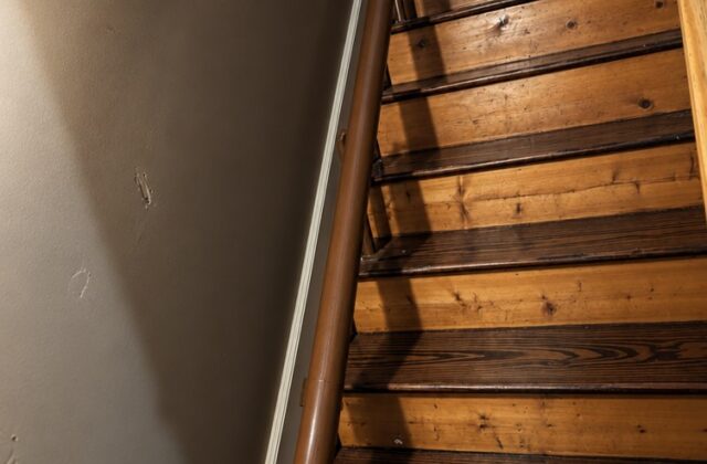 Handicare curved stairlift rail in brown following a turning wooden staircase