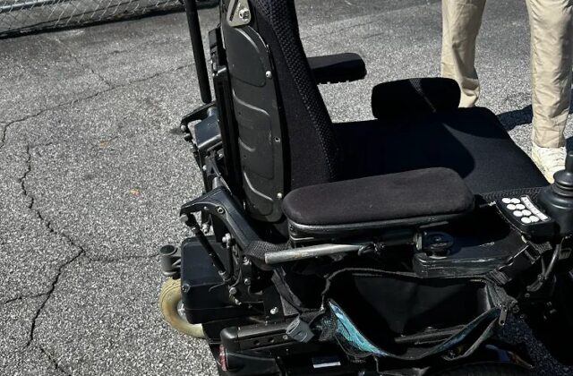 Permobil power wheelchair in a parking lot after a complex rehab repair