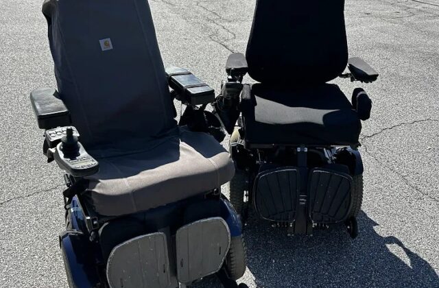 Two Permobil power wheelchairs side by side in a parking lot after complex rehab repairs