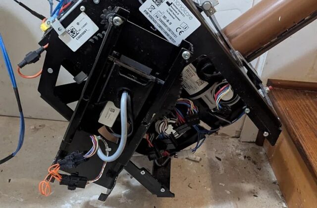 Handicare stairlift carriage removed from its curved rail during a repair